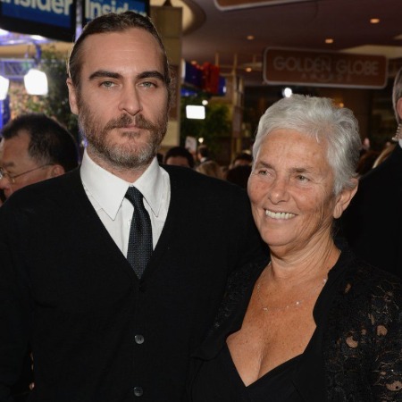 Arlyn Phoenix and her son Joaquin Phoenix in matching black outfit.